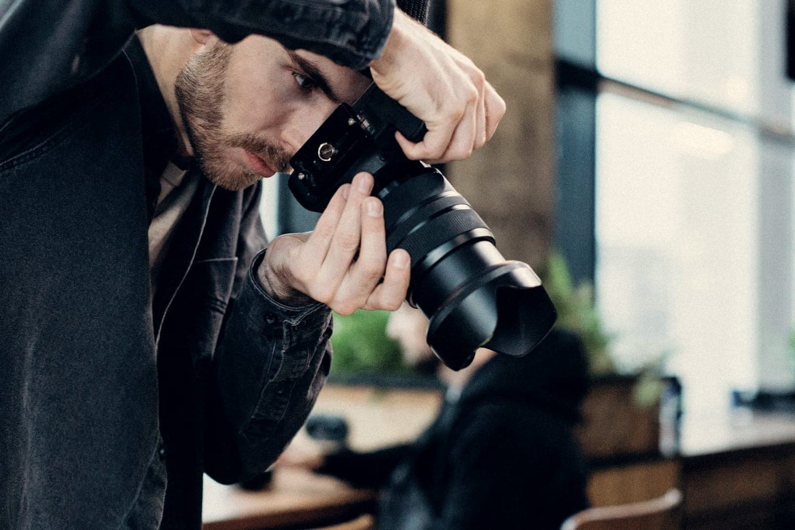 Photographer shooting with a DSLR camera in a studio